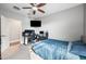 Bright bedroom featuring a ceiling fan, carpeting, and a doorway visible to another room at 2336 W Magdalena Ln, Phoenix, AZ 85041