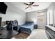 Comfortable bedroom with ceiling fan, a desk, and a well-lit atmosphere at 2336 W Magdalena Ln, Phoenix, AZ 85041