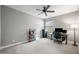 Spacious bedroom featuring neutral walls, carpet and a ceiling fan and desk space at 2336 W Magdalena Ln, Phoenix, AZ 85041