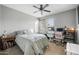 Cozy bedroom with a ceiling fan and multiple desks, offering both rest and workspace at 2336 W Magdalena Ln, Phoenix, AZ 85041