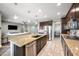 Modern kitchen with a large island, granite countertops, and stainless steel appliances at 2336 W Magdalena Ln, Phoenix, AZ 85041