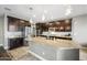 Well-equipped kitchen features granite countertops, dark wood cabinets, and stainless steel appliances at 2336 W Magdalena Ln, Phoenix, AZ 85041