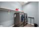 Efficient laundry room equipped with modern washer and dryer units and ample storage at 2336 W Magdalena Ln, Phoenix, AZ 85041