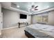 Well-lit main bedroom featuring a TV, modern desk and carpeted floors at 2336 W Magdalena Ln, Phoenix, AZ 85041
