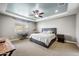 Stylish main bedroom featuring tray ceilings, recessed lights, and a ceiling fan at 2336 W Magdalena Ln, Phoenix, AZ 85041