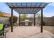 Outdoor kitchen with a built-in grill, set under a pergola in a landscaped backyard at 2336 W Magdalena Ln, Phoenix, AZ 85041