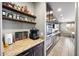Convenient pantry area with granite counters, open shelves, and an adjacent stainless steel oven at 2336 W Magdalena Ln, Phoenix, AZ 85041