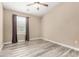 Bright bedroom featuring a ceiling fan, window with blinds, and modern wood-look flooring at 240 W Juniper Ave # 1053, Gilbert, AZ 85233