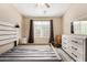 Bedroom featuring neutral walls, ceiling fan, and a window at 240 W Juniper Ave # 1053, Gilbert, AZ 85233