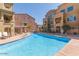 Charming community pool area with residential buildings in the background at 240 W Juniper Ave # 1053, Gilbert, AZ 85233