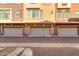 Row of garages with brick pavement; townhomes with neutral stucco exteriors, and various windows at 240 W Juniper Ave # 1053, Gilbert, AZ 85233