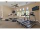 Bright community gym with treadmills, ceiling fan, and wall-mounted televisions at 240 W Juniper Ave # 1053, Gilbert, AZ 85233