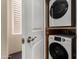 Stacked washer and dryer in a laundry room at 240 W Juniper Ave # 1053, Gilbert, AZ 85233