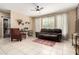 Bright living room featuring tiled floors, neutral paint, and a comfortable brown sofa at 240 W Juniper Ave # 1053, Gilbert, AZ 85233