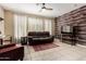 Inviting living room featuring a ceiling fan, wood accent wall, and comfortable seating at 240 W Juniper Ave # 1053, Gilbert, AZ 85233