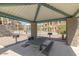 Covered pavilion with picnic table, seating, and BBQ grills surrounded by lush landscaping at 240 W Juniper Ave # 1053, Gilbert, AZ 85233