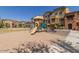 A community playground area in front of residential buildings on a sunny day at 240 W Juniper Ave # 1053, Gilbert, AZ 85233