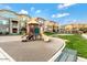 Community playground area with slides, swings, and green space for outdoor activities at 240 W Juniper Ave # 1053, Gilbert, AZ 85233