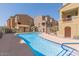A community pool surrounded by residential buildings on a sunny day at 240 W Juniper Ave # 1053, Gilbert, AZ 85233