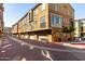 Street view featuring well-maintained townhomes with attached garages and exterior lighting at 240 W Juniper Ave # 1053, Gilbert, AZ 85233
