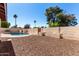 Enclosed backyard features a charming pool area, desert landscape, and privacy wall at 2416 S Evergreen Rd, Tempe, AZ 85282