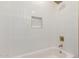 Bright bathroom features a white tub, gold fixtures and a recessed wall niche at 2416 S Evergreen Rd, Tempe, AZ 85282