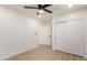 Neat bedroom featuring wood-look flooring, white sliding closet doors, and a ceiling fan at 2416 S Evergreen Rd, Tempe, AZ 85282
