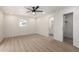 Spacious bright bedroom with large window, ceiling fan and view of the ensuite bathroom at 2416 S Evergreen Rd, Tempe, AZ 85282