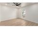 Clean bedroom showcasing a modern ceiling fan and a unique arch window at 2416 S Evergreen Rd, Tempe, AZ 85282