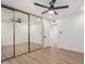 Well-lit bedroom features mirrored closet doors and a modern ceiling fan at 2416 S Evergreen Rd, Tempe, AZ 85282