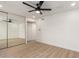 Light and airy bedroom featuring mirrored closet doors and a modern ceiling fan at 2416 S Evergreen Rd, Tempe, AZ 85282
