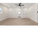 Spacious bright bedroom with large window, ceiling fan and view of the ensuite bathroom at 2416 S Evergreen Rd, Tempe, AZ 85282