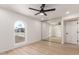 Bedroom features a ceiling fan, mirrored closet doors, and wood-look flooring at 2416 S Evergreen Rd, Tempe, AZ 85282