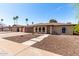 Charming single-story home featuring a brick facade, arched windows, a well-maintained yard, and long driveway at 2416 S Evergreen Rd, Tempe, AZ 85282