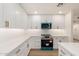 Bright kitchen features white cabinets, herringbone backsplash, quartz counters, and stainless appliances at 2416 S Evergreen Rd, Tempe, AZ 85282
