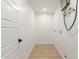Convenient laundry room with modern hookups, wood floors, and white walls at 2416 S Evergreen Rd, Tempe, AZ 85282