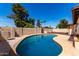 Private backyard pool surrounded by a decorative rockscape and lush landscaping at 2416 S Evergreen Rd, Tempe, AZ 85282