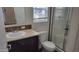 Modern bathroom featuring a stand-up shower with glass doors, and neutral countertops and cabinets at 2460 E Main St # F7, Mesa, AZ 85213