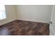 A cozy bedroom featuring wood-look tiling, ample natural light, and a clean, neutral color palette at 2460 E Main St # F7, Mesa, AZ 85213