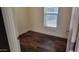 Compact bedroom with a window and hardwood floors, perfect for an office or guest room at 2460 E Main St # F7, Mesa, AZ 85213