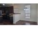 Bright dining area with stylish chandelier, large window, and hardwood flooring at 2460 E Main St # F7, Mesa, AZ 85213