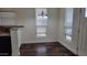 Light filled dining area with new chandelier, windows, and hardwood floors at 2460 E Main St # F7, Mesa, AZ 85213