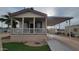 Charming single story home with covered porch, manicured lawn, and a convenient carport at 2460 E Main St # F7, Mesa, AZ 85213