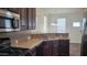 Well-lit kitchen featuring stainless steel appliances and a cozy breakfast bar area at 2460 E Main St # F7, Mesa, AZ 85213