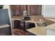 Modern kitchen with stainless steel appliances, rich wood cabinets, and light countertops at 2460 E Main St # F7, Mesa, AZ 85213