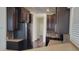 Spacious kitchen featuring dark wood cabinets, stainless appliances, and hardwood floors at 2460 E Main St # F7, Mesa, AZ 85213