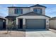 Two-story home featuring a spacious two-car garage, neutral colors, and low maintenance landscaping at 25215 W Wayland Dr, Buckeye, AZ 85326