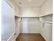 Walk-in closet featuring laminate flooring and clothing racks at 25215 W Wayland Dr, Buckeye, AZ 85326