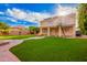 This property features a backyard with artificial grass, a covered patio, and solar panels on the roof at 25425 N 64Th Ave, Phoenix, AZ 85083