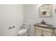 Powder room features pedestal sink with stone countertop and classic framed mirror at 25425 N 64Th Ave, Phoenix, AZ 85083
